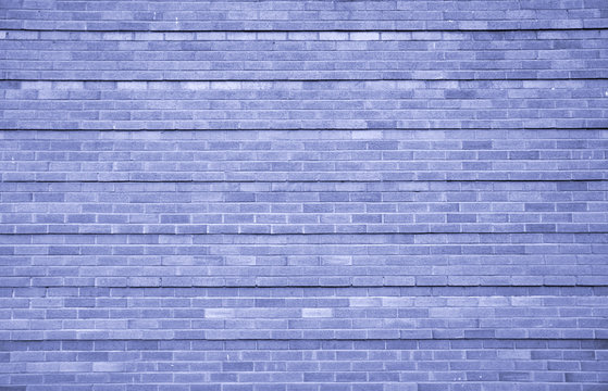 blue brick wall with textured bricks and repeating horizontal lines pattern