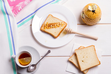 Fototapeta na wymiar BREAKFAST CONCEPT fried bread toast with honey