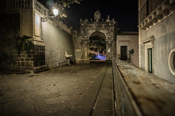 The entrance to Villa Cerami (home of the faculty of Law) on the Street Crociferi photographed at night - Catania, Sicily, Italy.