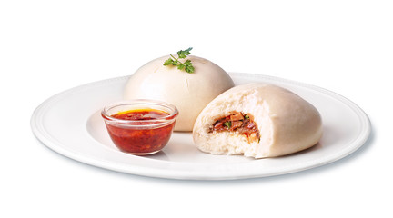 two steamed buns bakpao on a white plate