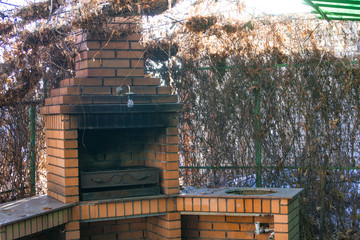 chimney barbecue in a live fence in autumn