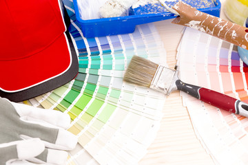 Color palette guide and painting supplies, paint brushes and color cans on wooden background
