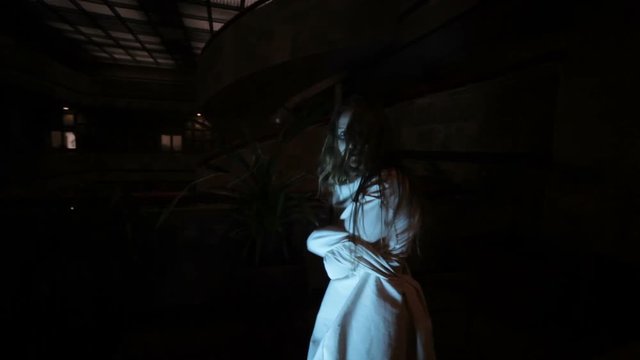 Terrible woman in a straitjacket, she wants to escape.