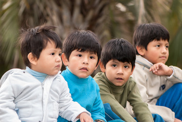 Latin brothers sitting in park