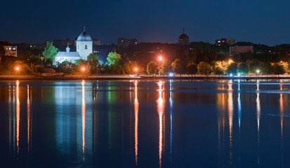 Panorama night city with reflection in the water. Europe, Ukraine, Ternopil.