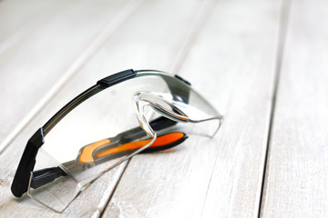 safety glasses on wooden plank