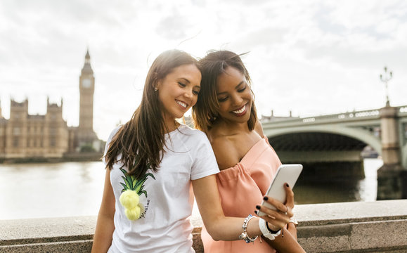 UK, London, two beautiful women taking a selfie near Westminster Bridge