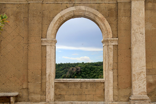 Fototapeta Italian view through the arch window in Sorano, Tuscany, Italy.