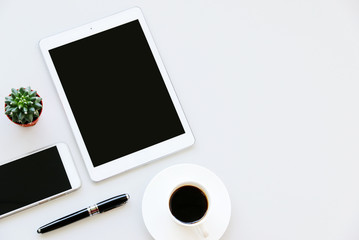 Office table with tablet,smartphone,pen,coffee cup and cactus, copy space,Top view, flat lay