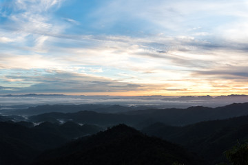 Fototapeta na wymiar Mountain forest landscape under sunrise sky with clouds.