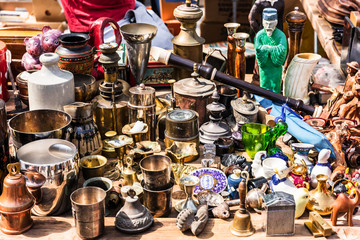 Old vintage objects and furniture at a garage sale at the flea market in Paris. France