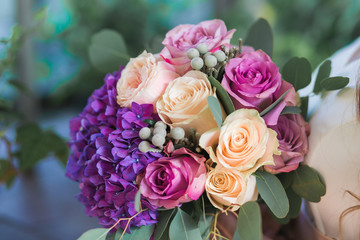 Wedding flowers in a bouquet, purple hydrangeas, eucalyptus and roses