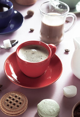 cup of coffee, tea and cacao at purple background