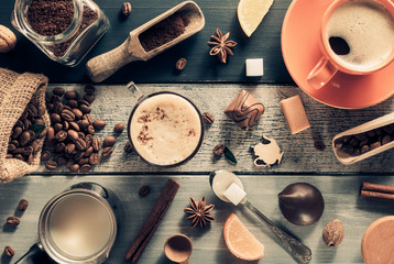 cup of coffee and ingredients on wood