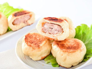 pan-fried bun in white plate isolated on white background