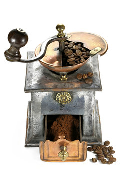 vintage coffee grinder with manufacture roasted Indonesian Arabica coffee beans isolated on white background