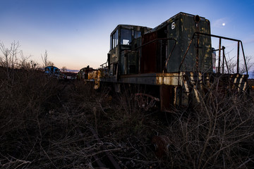 Fototapeta premium Derelict Locomotive at Twilight - Abandoned Railroad Trains