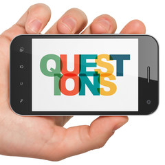 Education concept: Hand Holding Smartphone with Painted multicolor text Questions? on display, 3D rendering