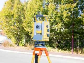 Surveyor equipment telescope at construction site, Surveying for making contour plans are a graphical representation of the lay of the land before startup construction work