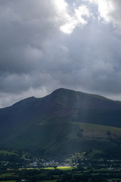 The heaven breaks open and clouds move aside lighting up the beautiful countryside of Keswick England