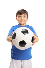 Little boy giving a football