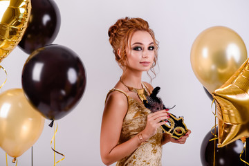 beautiful girl with balloons in the studio, celebrating the new year