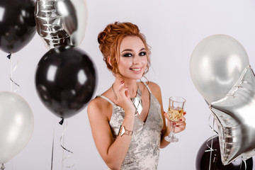 beautiful girl with balloons in the studio, celebrating the new year