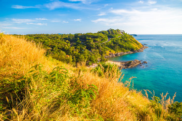 Beautiful stone rocky sea beach with yellow grass at Phuket island