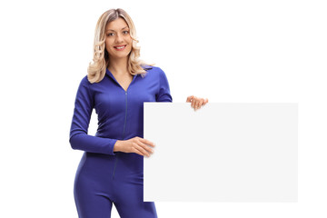 Woman in a racing suit holding a blank banner © Ljupco Smokovski
