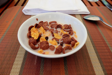 Corn flakes in a bowl with spoon for eating
