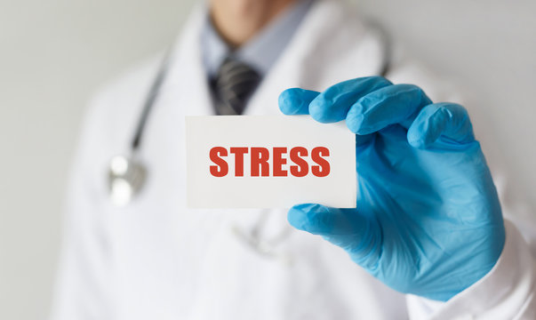 Doctor holding a card with text STRESS,medical concept