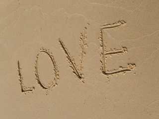  LOVE  inscription on a sandy beach