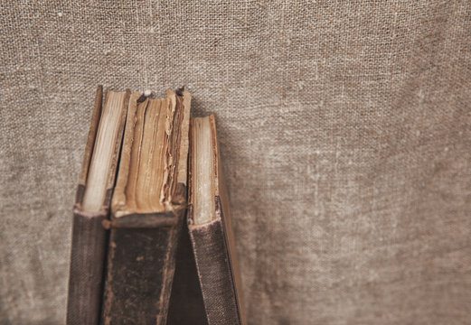 Vintage old books on the old burlap fabric