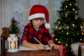 Adorable little boy, writing letter to Santa