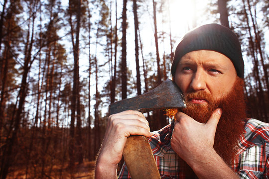 a lumberjack works with an axe in the forest