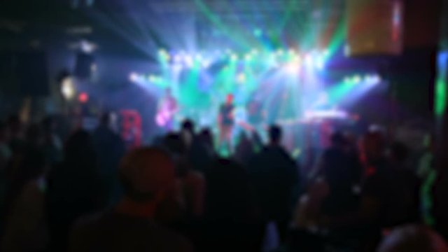 Band on Stage with Crowd Blur Light Show. a blurred shot of a band and crowd during a performance with multi-color light show
