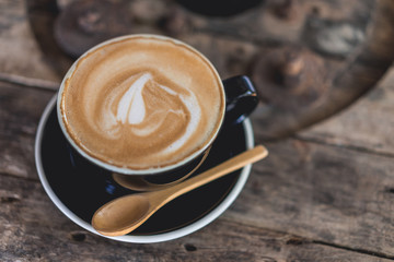 Coffee cup and coffee beans on wood table ,warm and good smell