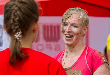 Smiling tired girl. / The girl smiles and emotionally communicates after completing the race along...