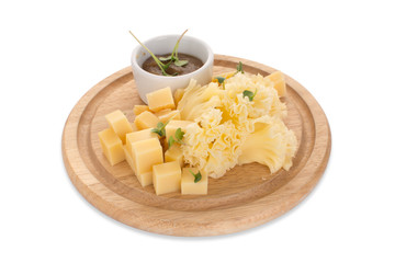 From above cauliflower and cheese with sauce served on wooden circle.