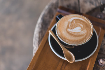 Coffee cup and coffee beans on wood table ,warm and good smell
