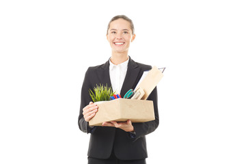 Portrait of female employee holding box with belongings