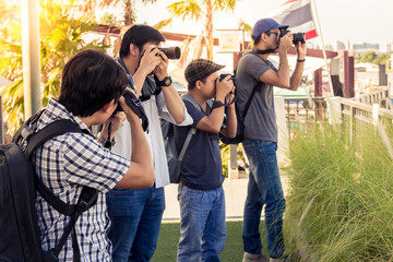 Group of men are standing photograph on the riverside in Thailand.