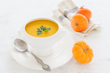 vegetable soup orange in a white deep soup plate. vegetarian soup macro