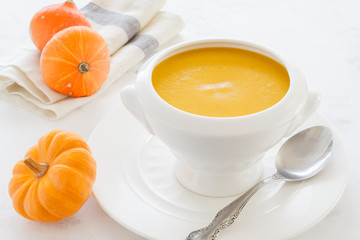 vegetable soup orange in a white deep soup plate. vegetarian soup macro