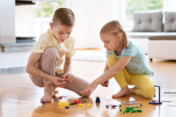 Fototapeta premium Two curious happy children playing with game