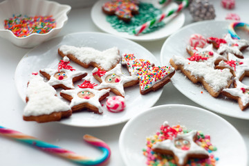 Christmas sweets baking gingerbread cookies on plate, Christmas cookies gingerbread on white light table. New Year food