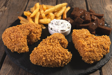 fried chicken wings breaded crispy with french fries fried rye bread croutons beer snack