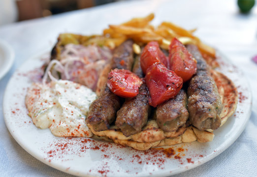Greek Souvlaki. Lamb Skewer on a Plate with Potatoes and Tzatziki, Geece