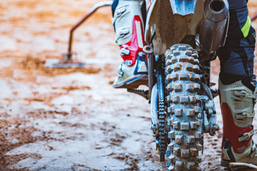 Close-up of biker sitting on motorcycle in starting point before the start of the race