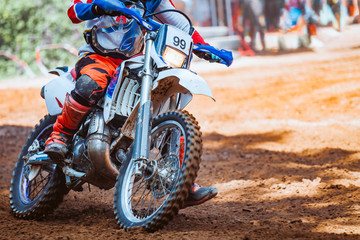 Close-up part of mountain bikes race in dirt track in sunshine day time. Concept focus of during an acceleration in action sport